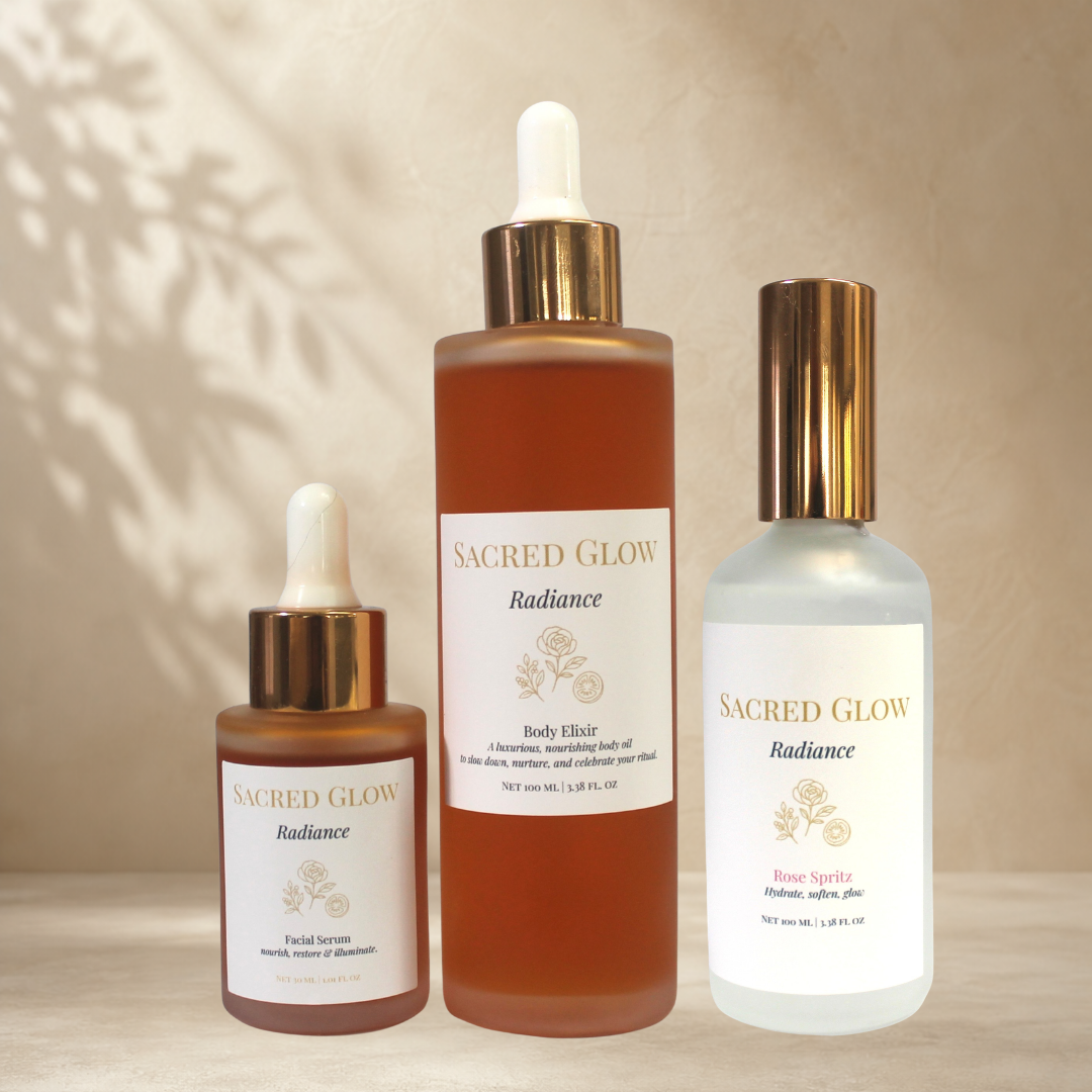 Sacred Glow Radiance Signature Ritual gift set displayed with Facial Serum, Body Elixir and Rose Spritz.